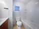 Clean bathroom with a tub, toilet and wood vanity at 5339 Brookmeade Dr, Sarasota, FL 34232