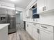 Modern kitchen with white shaker cabinets, stainless steel appliances and quartz countertops at 5339 Brookmeade Dr, Sarasota, FL 34232