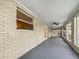 Spacious screened porch with brick walls and ceiling fan at 5339 Brookmeade Dr, Sarasota, FL 34232