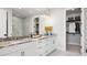 Bathroom with double vanity, marble countertops, and walk-in closet at 14517 Coastal Woodland Ln, Parrish, FL 34219