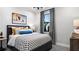Bright bedroom with a black platform bed and patterned bedding at 14517 Coastal Woodland Ln, Parrish, FL 34219