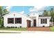 One-story home with brown roof, white walls, and brown accents at 14517 Coastal Woodland Ln, Parrish, FL 34219