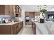 Modern kitchen with wood cabinets, marble countertops, and stainless steel appliances at 14517 Coastal Woodland Ln, Parrish, FL 34219