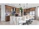 Modern kitchen with an island, wood cabinets, and marble countertops at 14517 Coastal Woodland Ln, Parrish, FL 34219