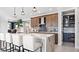 Modern kitchen with island seating, wood cabinets, and walk-in pantry at 14517 Coastal Woodland Ln, Parrish, FL 34219
