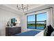 Main bedroom with lake view, dresser, and large windows at 14517 Coastal Woodland Ln, Parrish, FL 34219