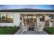 Evening view of backyard patio with fire pit and outdoor kitchen at 14517 Coastal Woodland Ln, Parrish, FL 34219