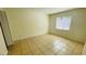 Bright bedroom with tile floors and window at 5504 Pokeweed Ct # 154, Tampa, FL 33617