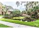 Peaceful community pond with a wooden bridge and surrounding foliage at 5504 Pokeweed Ct # 154, Tampa, FL 33617