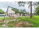 Community playground with swings and a slide, near a tennis court at 5504 Pokeweed Ct # 154, Tampa, FL 33617