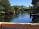 Serene canal view with lush vegetation and private docks at 6540 Marius Rd, North Port, FL 34287