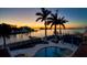 Stunning sunset view from backyard with pool, patio, and gazebo at 103 Shore Dr, Dunedin, FL 34698