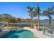 Serene pool and spa with water access and palm trees at 103 Shore Dr, Dunedin, FL 34698