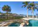 Enjoy the resort-style spa and freeform pool with a tranquil view at 103 Shore Dr, Dunedin, FL 34698