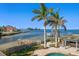 Stunning waterfront view with private dock and tropical landscaping at 103 Shore Dr, Dunedin, FL 34698