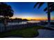 Scenic waterfront view at sunset, with palm trees at 103 Shore Dr, Dunedin, FL 34698