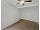 Spacious bedroom with wood-look flooring and ceiling fan at 10510 114Th Ter, Largo, FL 33773