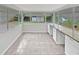 Bright sunroom features tile flooring and granite countertops at 10510 114Th Ter, Largo, FL 33773