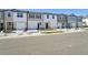 Row of townhouses showcasing attached garages and neat landscaping at 11873 Sylvia St, Dade City, FL 33525