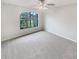 Well-lit bedroom with ceiling fan and large window at 7224 Highland Loop, Zephyrhills, FL 33541