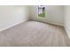 Spacious bedroom with neutral carpeting and large window at 7224 Highland Loop, Zephyrhills, FL 33541