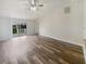 Bright living room with vinyl flooring and sliding glass doors leading to backyard at 7224 Highland Loop, Zephyrhills, FL 33541