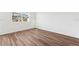 Empty bedroom with wood-look floors and a playground view at 11858 Sylvia St, Dade City, FL 33525