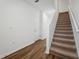 Staircase with brown carpet and wood flooring at 11858 Sylvia St, Dade City, FL 33525