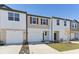 Two-story townhome with attached garage and landscaped yard at 6196 Pina Colada St, Zephyrhills, FL 33542