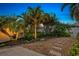 Landscaped backyard with stone path and tropical plants at 7419 Roxye Ln, Sarasota, FL 34240