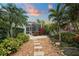 Landscaped backyard with stone path and lush tropical plants at 7419 Roxye Ln, Sarasota, FL 34240