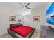 Comfortable bedroom with a large TV and red bedding at 7419 Roxye Ln, Sarasota, FL 34240