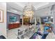 Elegant dining room with glass table, unique chairs, and a stunning chandelier at 7419 Roxye Ln, Sarasota, FL 34240