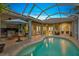 Inviting pool area with outdoor kitchen and seating at 7419 Roxye Ln, Sarasota, FL 34240