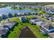 Aerial view of house near lake in a neighborhood at 2546 Buckthorn Loop, North Port, FL 34289