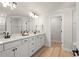 Modern bathroom with double vanity, quartz countertop, and a large mirror at 2546 Buckthorn Loop, North Port, FL 34289