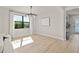 Bright dining room with hardwood floors and large window at 2546 Buckthorn Loop, North Port, FL 34289