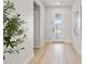 Light and bright entryway with light hardwood floors and a view to the interior at 2546 Buckthorn Loop, North Port, FL 34289