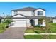 Two-story house with a white exterior, gray roof, and a two-car garage at 2546 Buckthorn Loop, North Port, FL 34289