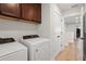 Bright laundry room with washer, dryer, and storage at 2546 Buckthorn Loop, North Port, FL 34289