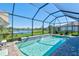 Enclosed pool and patio area with lake view and plenty of sunlight at 2546 Buckthorn Loop, North Port, FL 34289