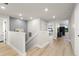 Upstairs hallway with light hardwood floors and access to bedrooms at 2546 Buckthorn Loop, North Port, FL 34289