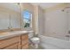 Clean bathroom with tub, shower, and wood cabinets at 1006 Vista Cay Ct, Brandon, FL 33511
