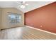 Large bedroom with vaulted ceiling, wood floors and accent wall at 1006 Vista Cay Ct, Brandon, FL 33511
