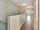 Upstairs hallway with light walls and wood floors at 1006 Vista Cay Ct, Brandon, FL 33511