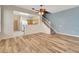 Open living room with wood-look floors and view of kitchen at 1006 Vista Cay Ct, Brandon, FL 33511