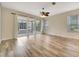 Living area with wood-look floors, sliding doors to patio, and neutral walls at 1006 Vista Cay Ct, Brandon, FL 33511