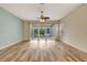 Living room with wood-look floors, ceiling fan, and access to patio at 1006 Vista Cay Ct, Brandon, FL 33511
