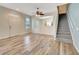 Living room features wood-look floors, ceiling fan, and staircase at 1006 Vista Cay Ct, Brandon, FL 33511