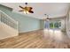 Spacious living room with wood-look floors, ceiling fan, and sliding glass doors at 1006 Vista Cay Ct, Brandon, FL 33511